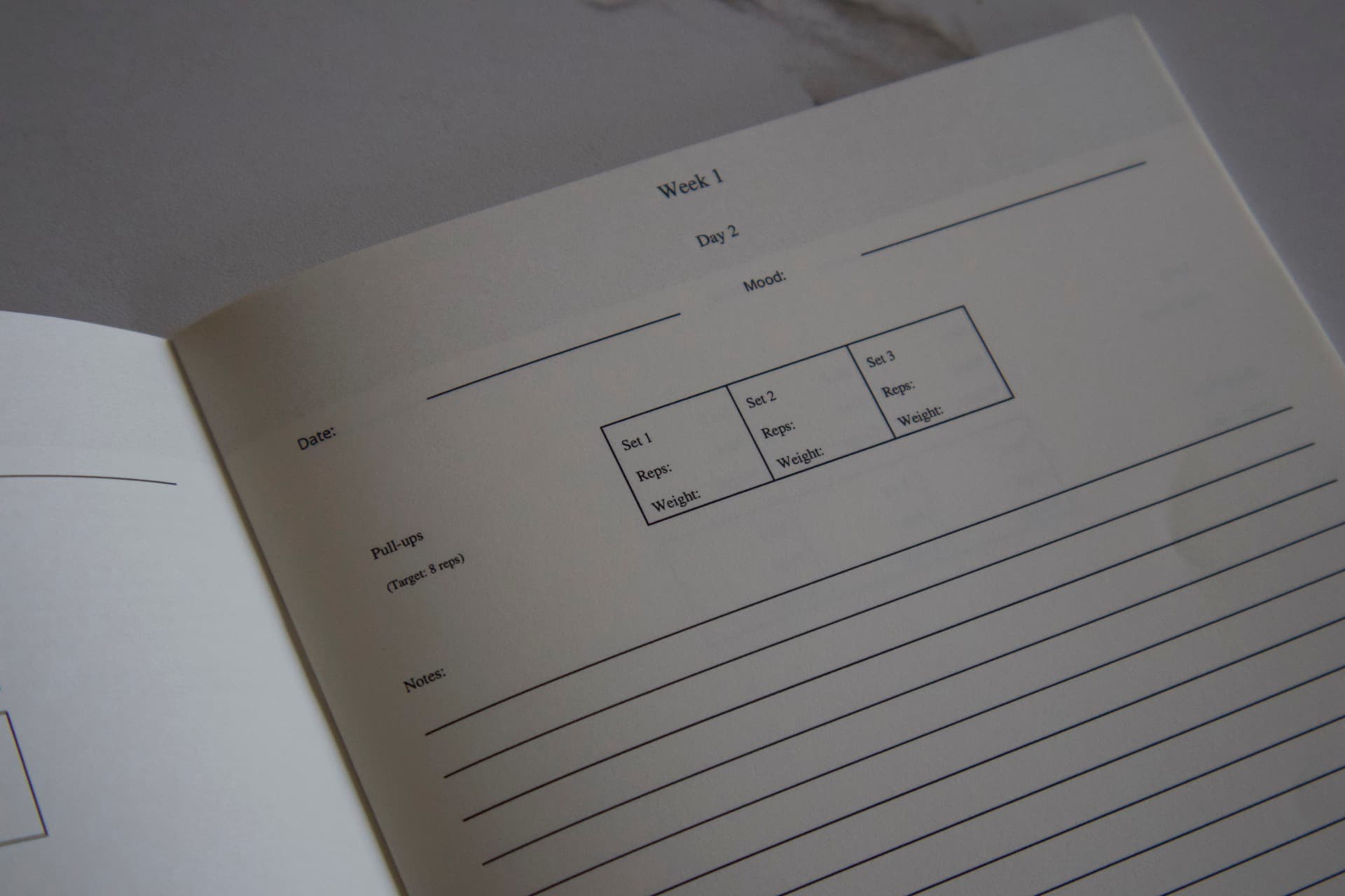 Custom ForgeLogbooks workout logbook on display with program-specific layout